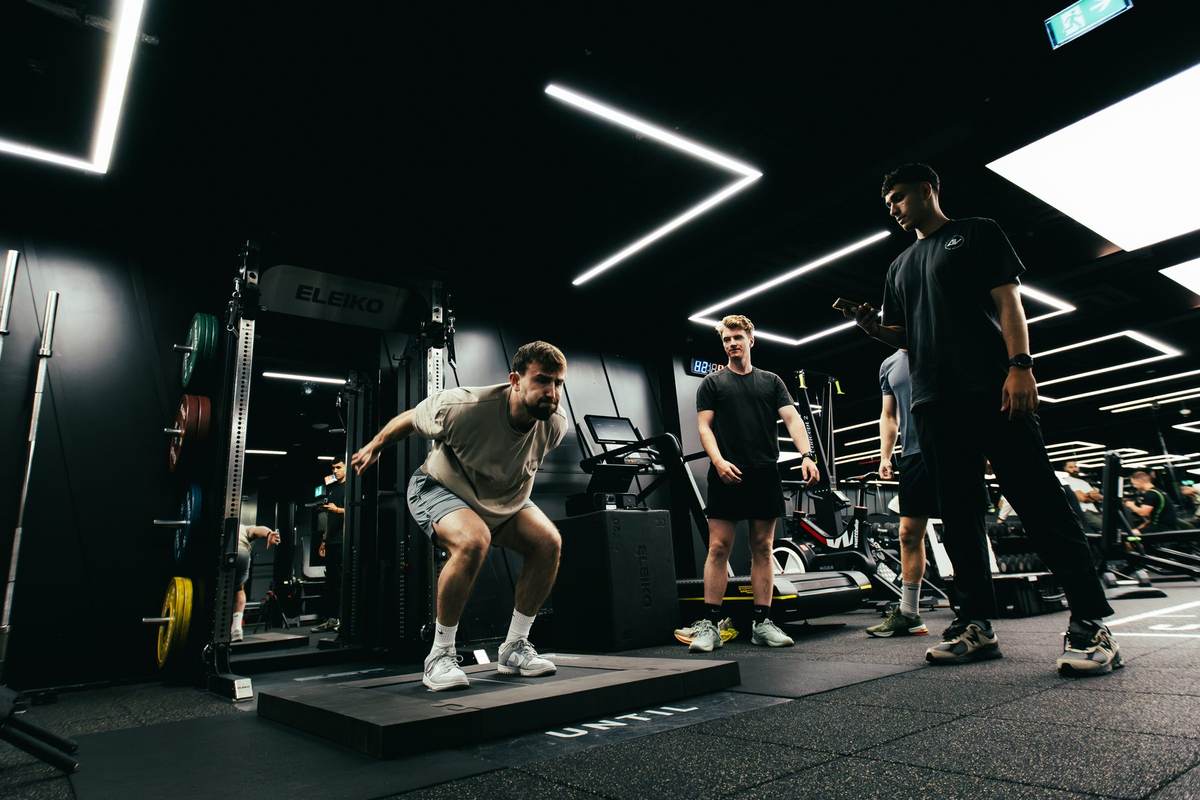 Coaches observing an athlete during a session at DVOTION Labs London