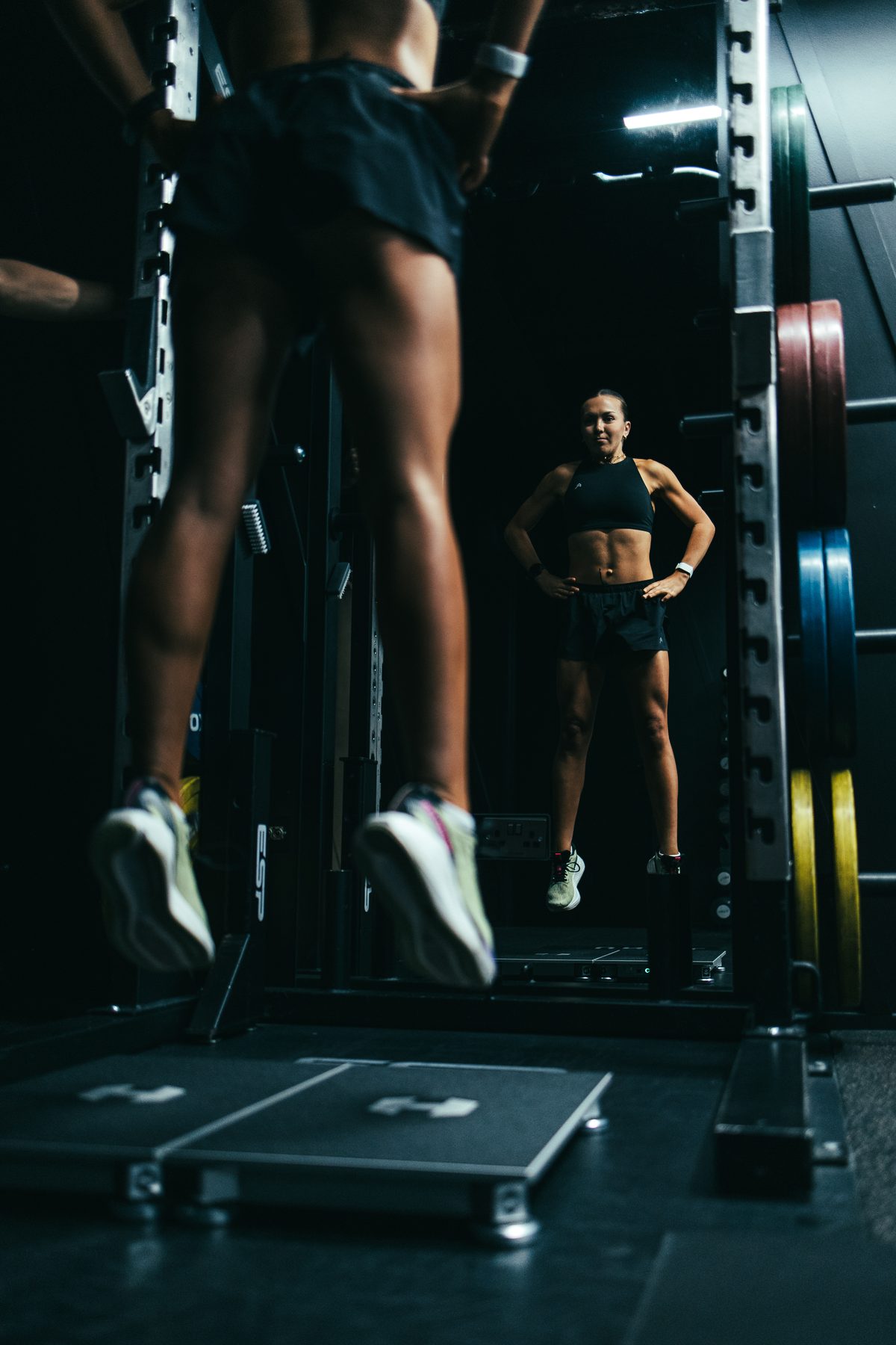 Athlete on the force plates between the uprights of a rack at DVOTION Labs London