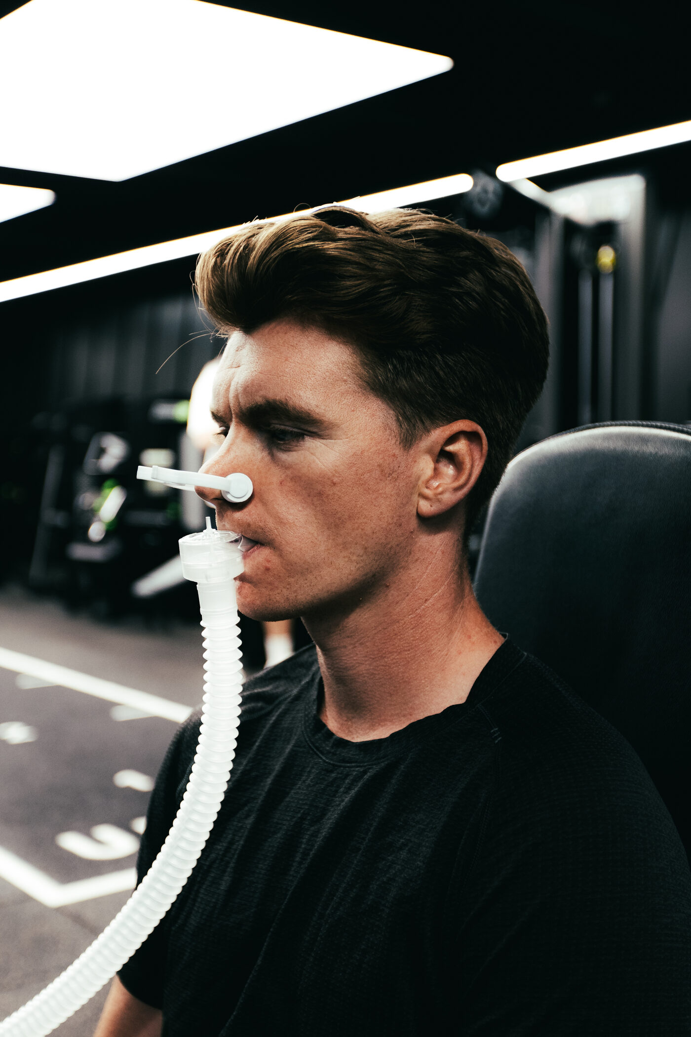 Athlete breathing into the analyser with a nose clip fitted during resting metabolic rate testing at DVOTION Labs London