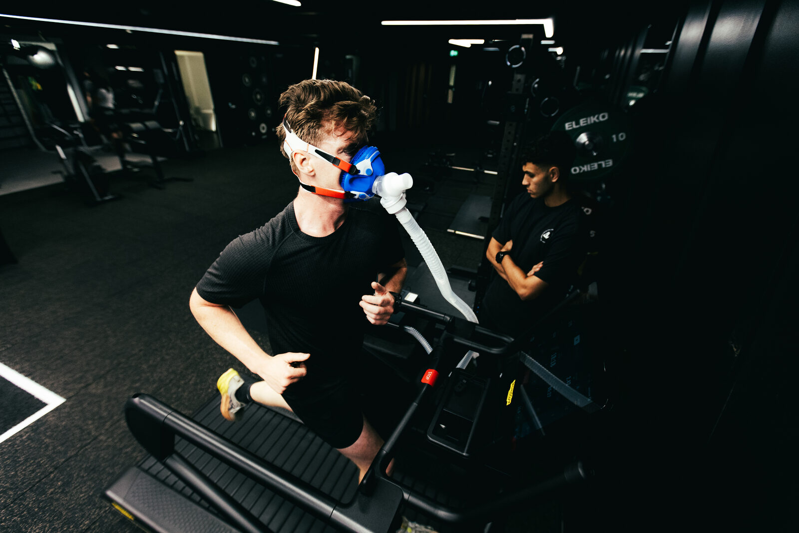 Athlete running a treadmill test in a metabolic mask while a coach observes, at DVOTION Labs London