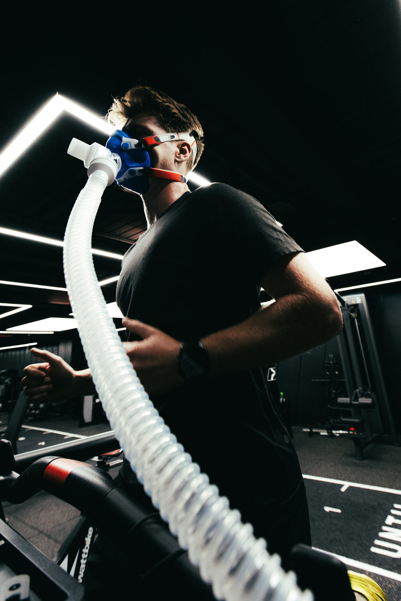 Cyclist wearing a metabolic mask during endurance profiling on a Wattbike at DVOTION Labs London